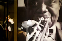 a black and white photograph of a man playing a trumpet