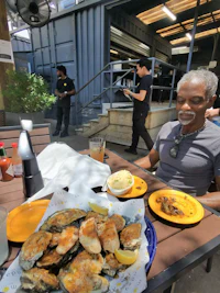 a man sitting at a table with a plate of food