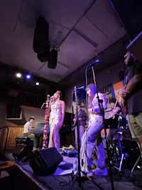 a group of people performing on stage in a dark room